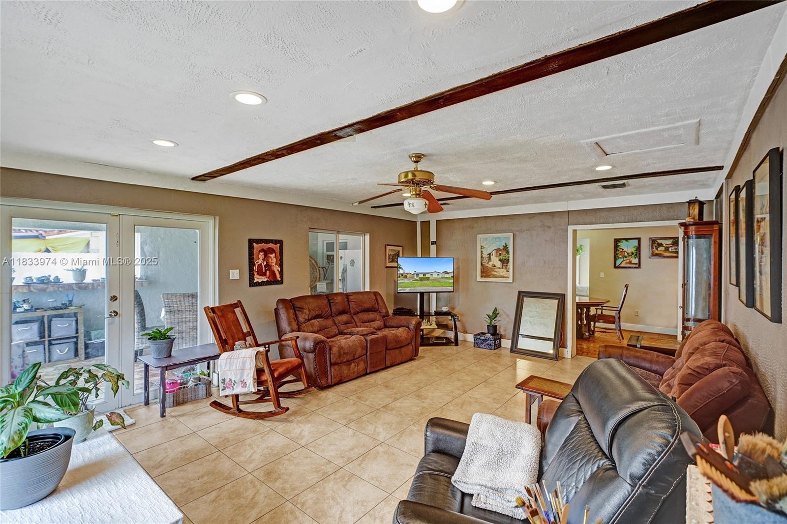 12763 Southwest 45th Terrace Miami, FL 33175 - Photo 21 of 30 a living room with furniture and a flat screen tv