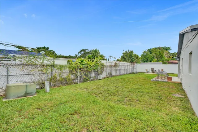 a view of backyard with a garden and plants