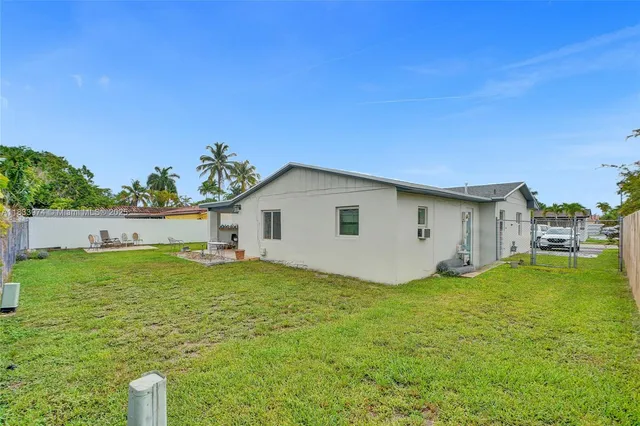 a view of a backyard with plants and a patio