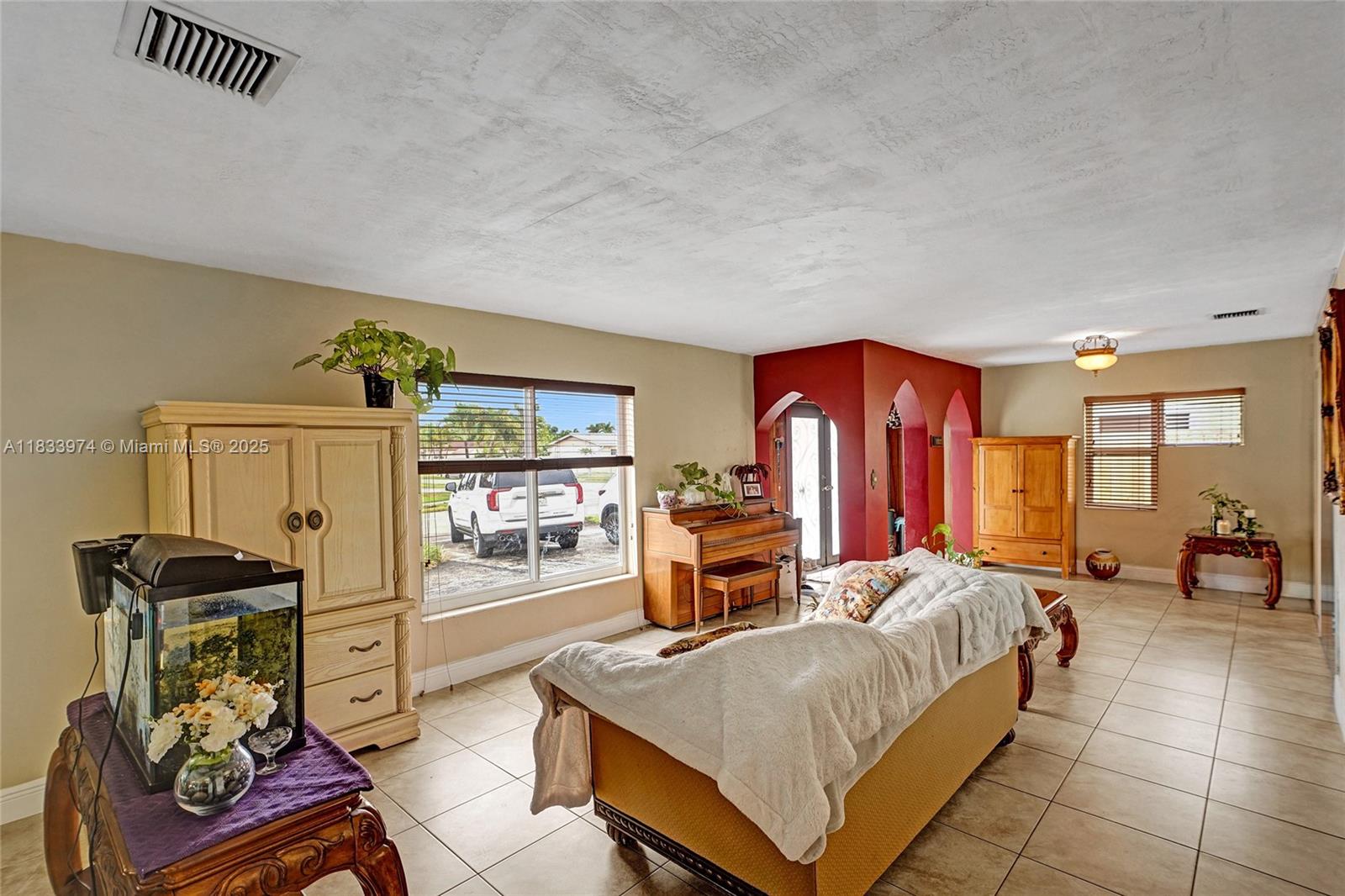 12763 Southwest 45th Terrace Miami, FL 33175 - Photo 5 of 30 a bedroom with furniture and large windows