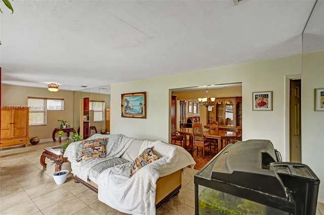 a living room with dining table furniture and a chandelier