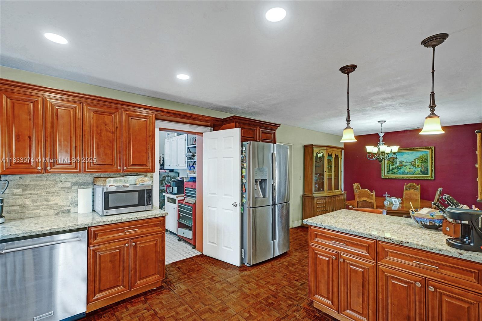12763 Southwest 45th Terrace Miami, FL 33175 - Photo 8 of 30 a kitchen with stainless steel appliances granite countertop a refrigerator and a sink