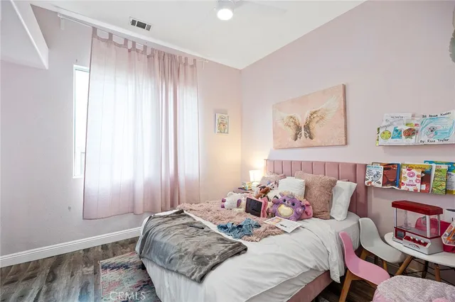 a bedroom with bed and a window