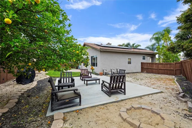 a backyard of a house with table and chairs