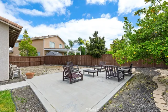 a view of a backyard with sitting area