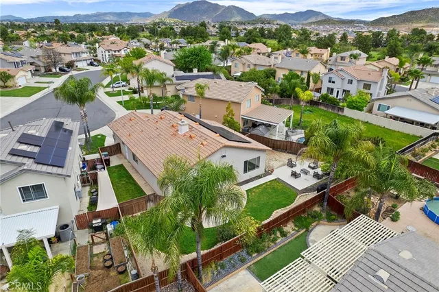 an aerial view of residential houses with outdoor space and parking