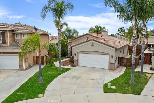 front view of house with a yard and potted plants