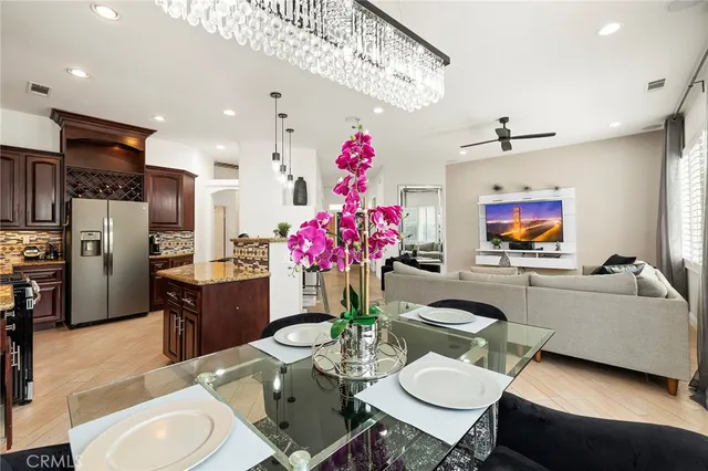 a living room with furniture kitchen and a chandelier