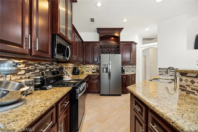 a kitchen with refrigerator and stove