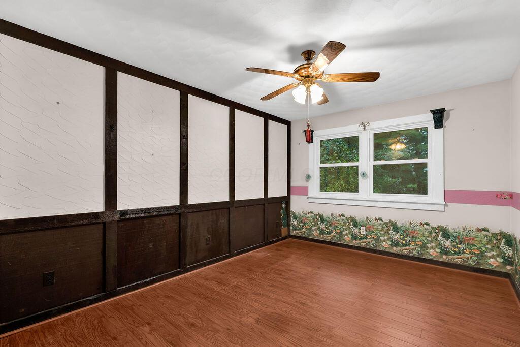 4409 Newton Road Northeast Newark, OH 43055 - Photo 49 of 87 • Neutral vinyl flooring • Ivory painted walls • Lighted ceiling fan • Faux fireplace • Lighted closet with bi-fold doors