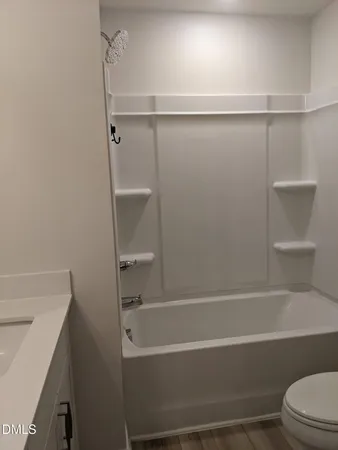 a bathroom with a shower and a toilet