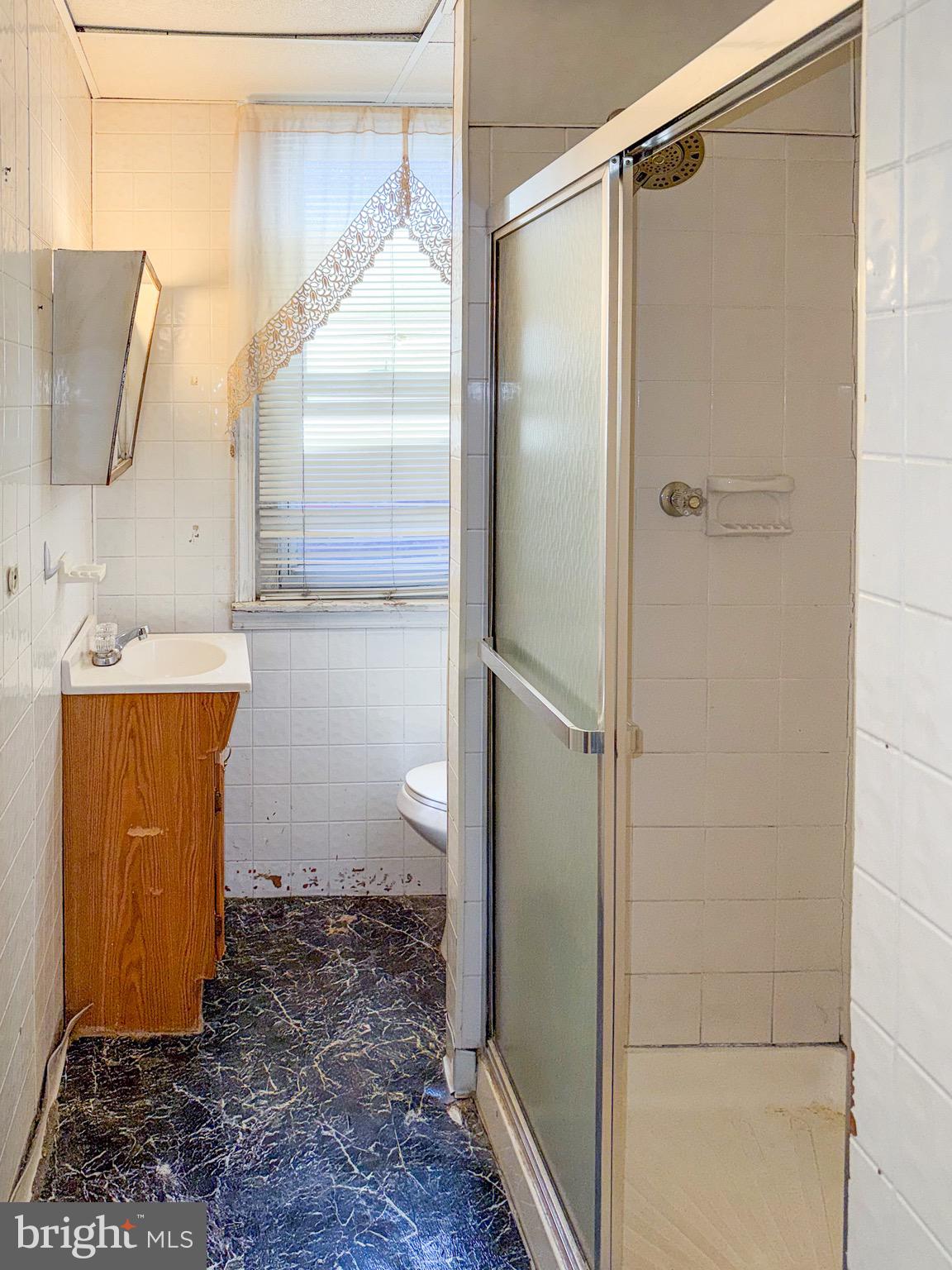 6519 Marsden Street Philadelphia, PA 19135 - Photo 19 of 24 a bathroom with a sink a toilet and shower