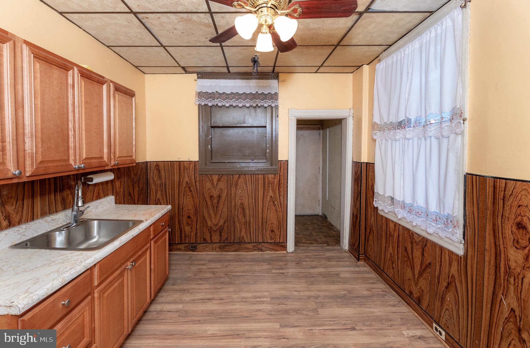 6519 Marsden Street Philadelphia, PA 19135 - Photo 6 of 24 a kitchen with kitchen island granite countertop a sink and a refrigerator