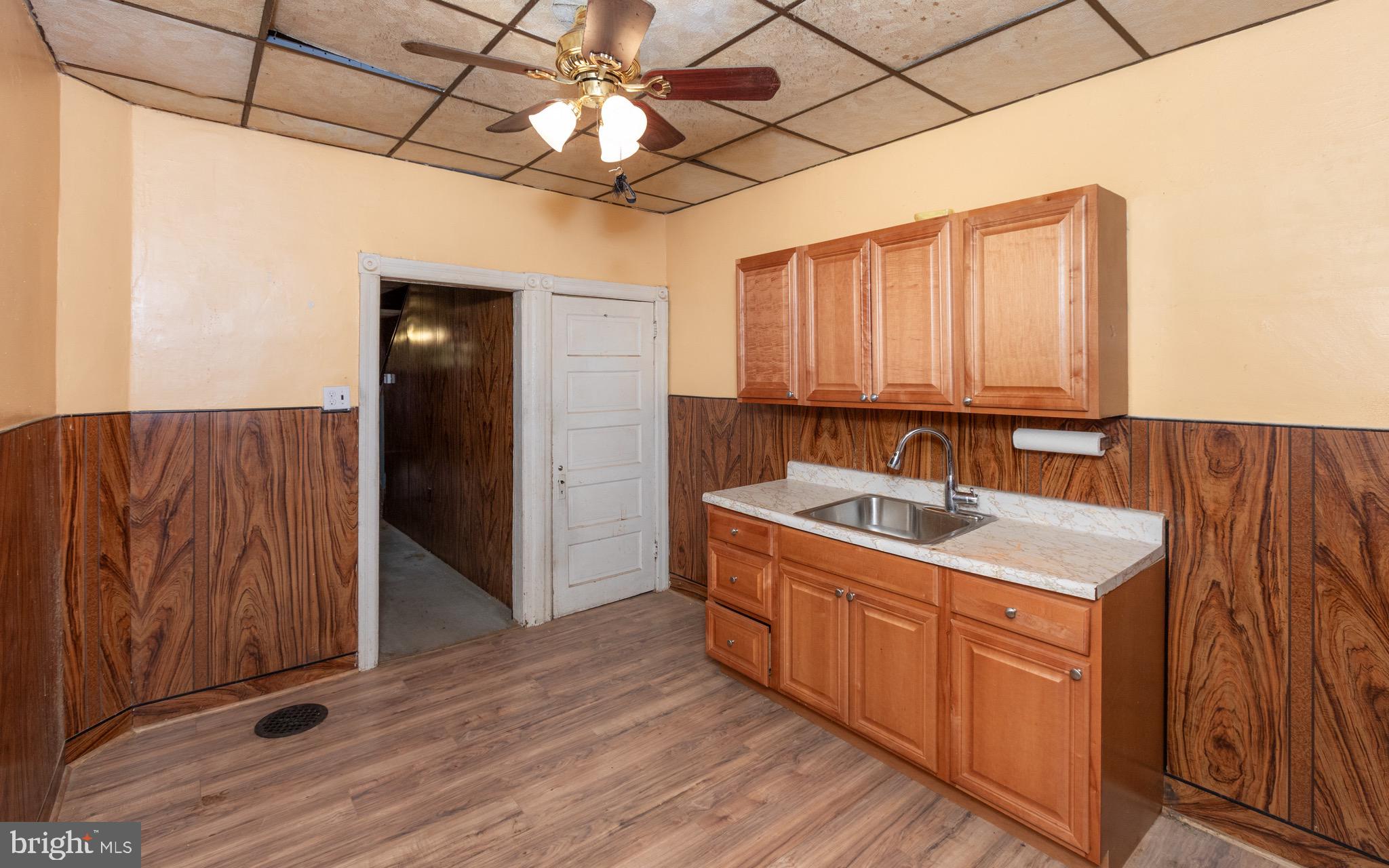 6519 Marsden Street Philadelphia, PA 19135 - Photo 8 of 24 a view of a kitchen with a sink and cabinets