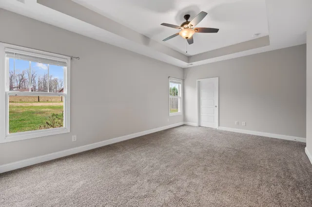 a view of room with window and ceiling fan