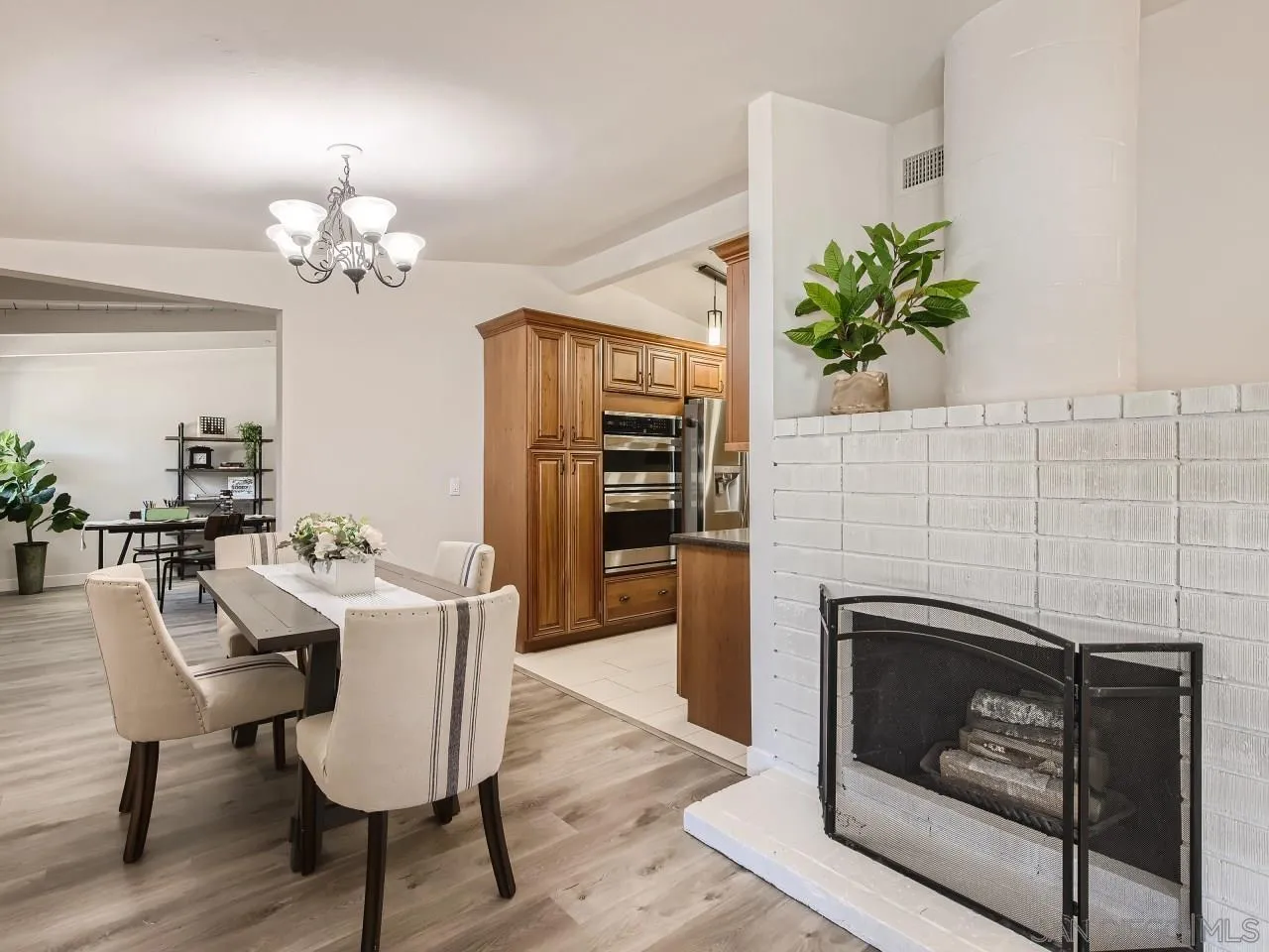 14000 Powers Road Poway, CA 92064 - Photo 6 of 27 a view of a dining room with furniture wooden floor and a fireplace