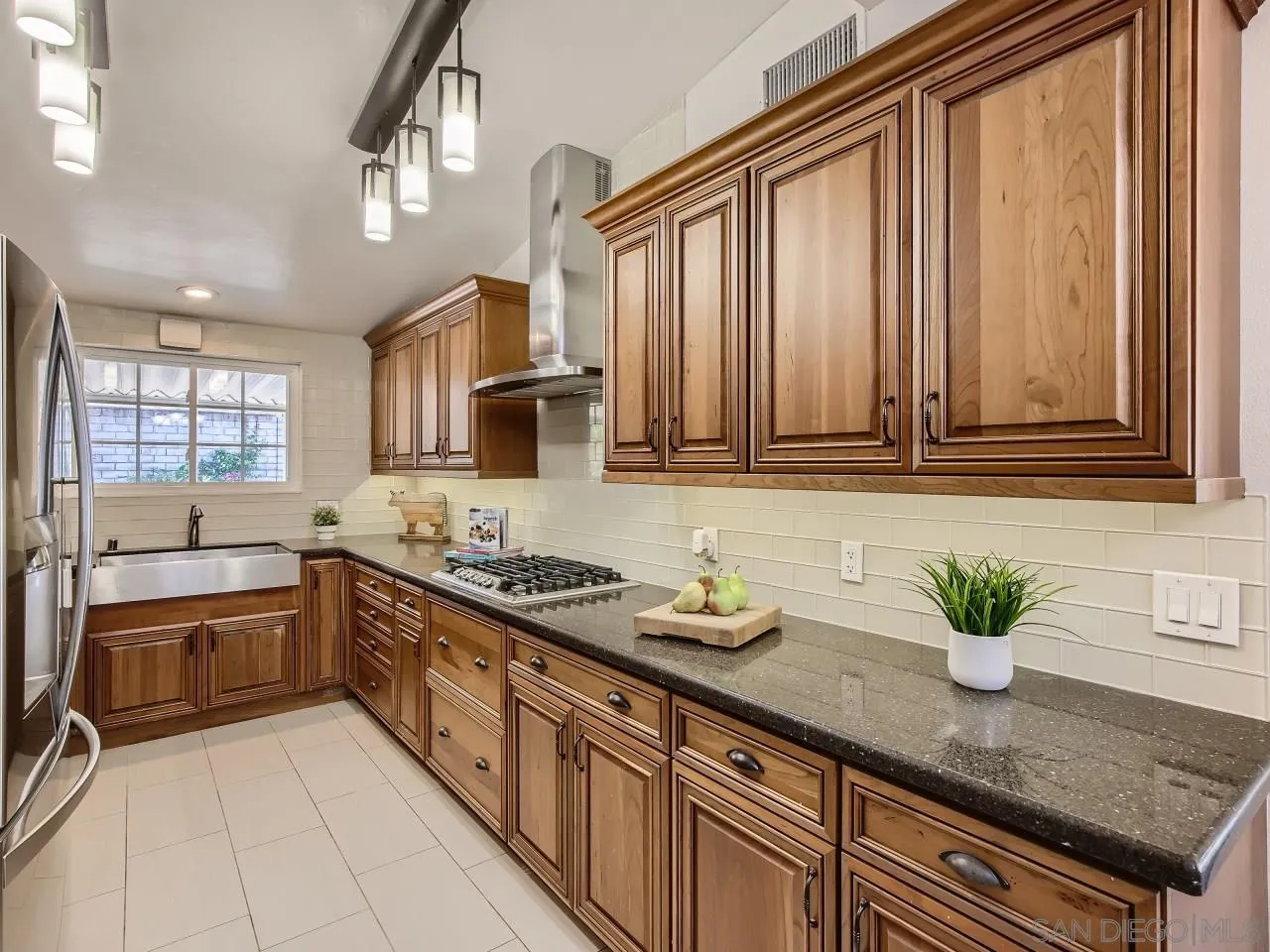 14000 Powers Road Poway, CA 92064 - Photo 8 of 27 a kitchen with stainless steel appliances granite countertop a sink a stove and cabinets
