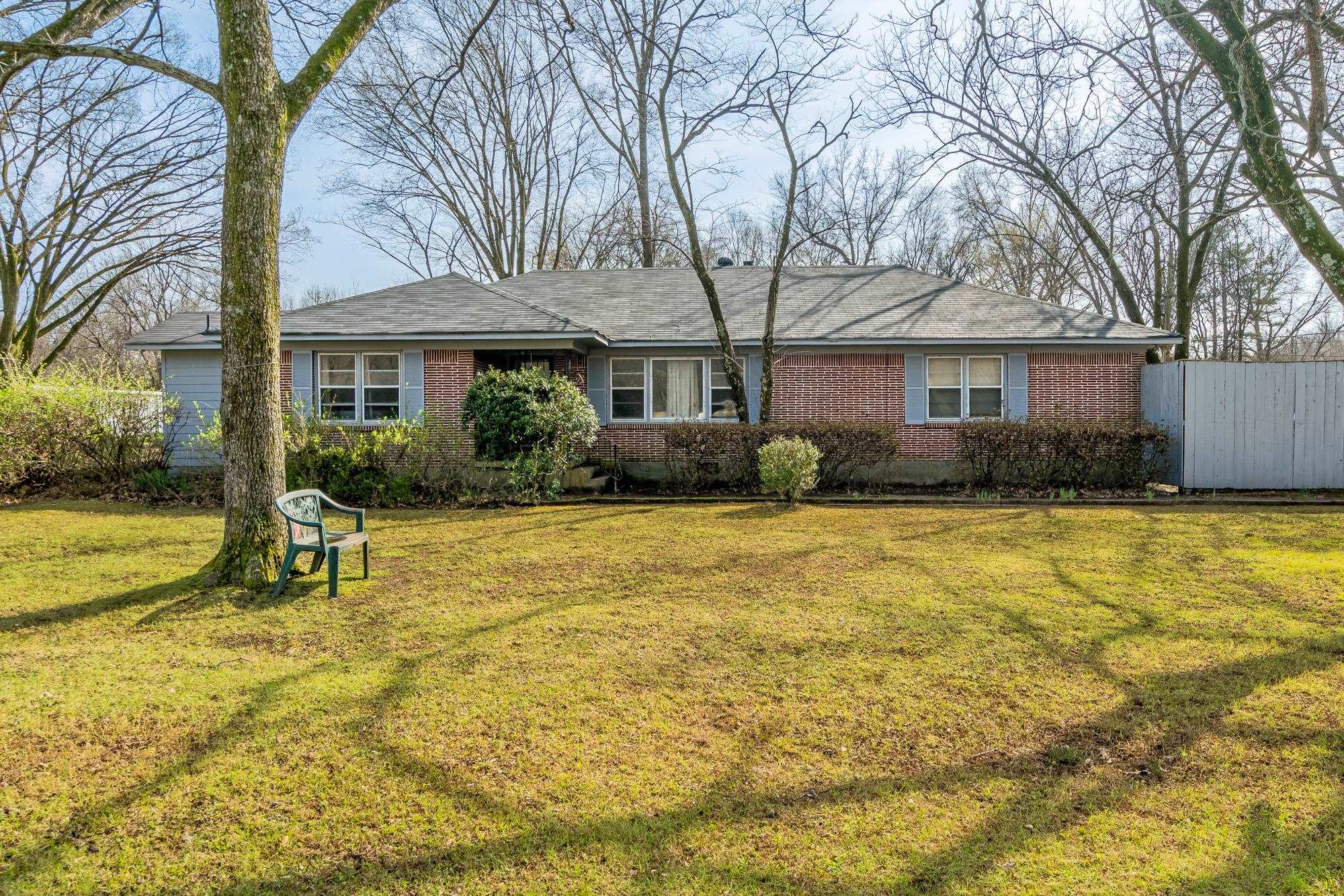 a house view with swimming pool in front of it
