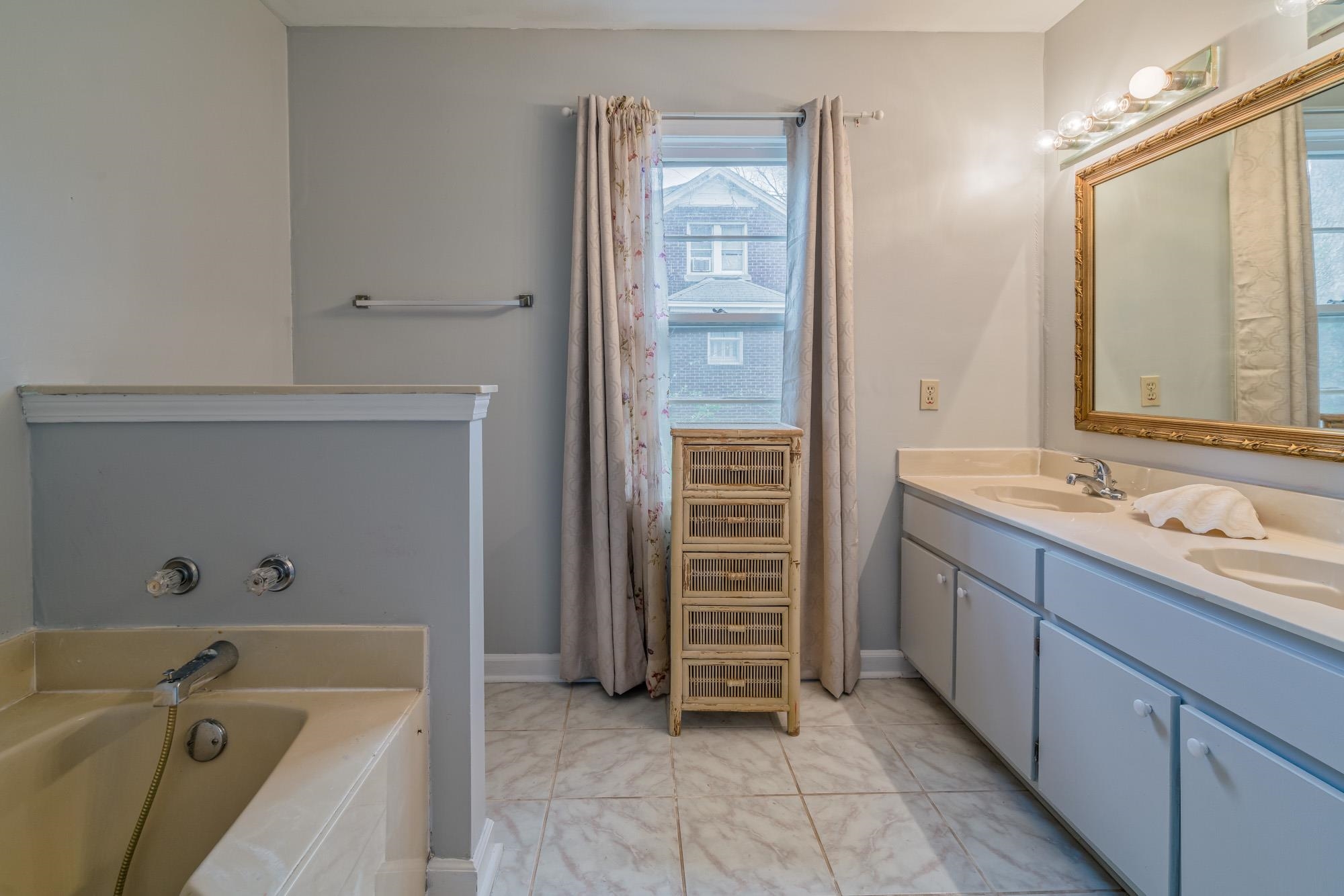3087 James Road Memphis, TN 38128 - Photo 16 of 25 a bathroom with a tub sink and mirror