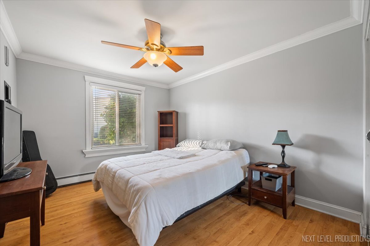 2100 Light Road, Unit 109 Oswego, IL 60543 - Photo 13 of 17 a bedroom with a bed and a chandelier