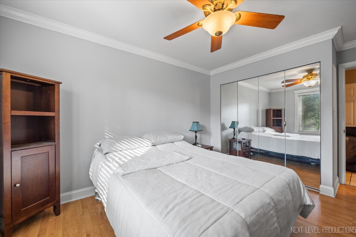 2100 Light Road, Unit 109 Oswego, IL 60543 - Photo 14 of 17 a bedroom with a bed and a chandelier