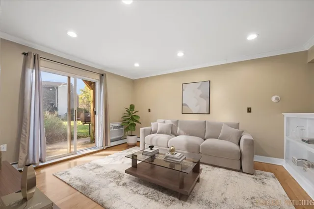 a living room with furniture and a floor to ceiling window
