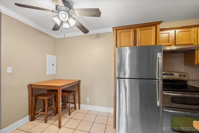 a white refrigerator freezer and a stove sitting inside of a kitchen