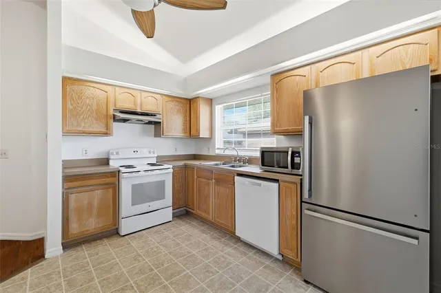 a kitchen with a refrigerator sink and stove