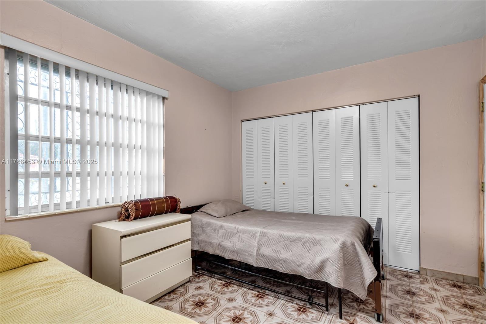 35 Southwest 60th Avenue Miami, FL 33144 - Photo 11 of 27 a bedroom with a bed and a window