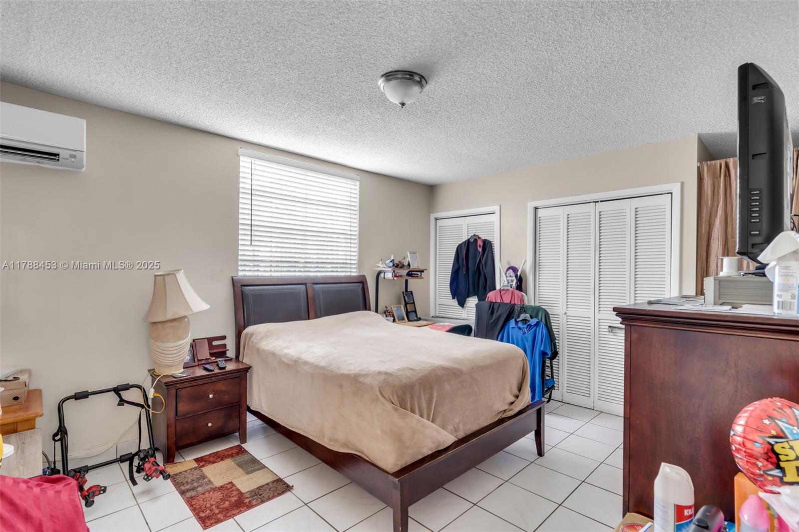 35 Southwest 60th Avenue Miami, FL 33144 - Photo 20 of 27 a bedroom with a bed and wooden floor