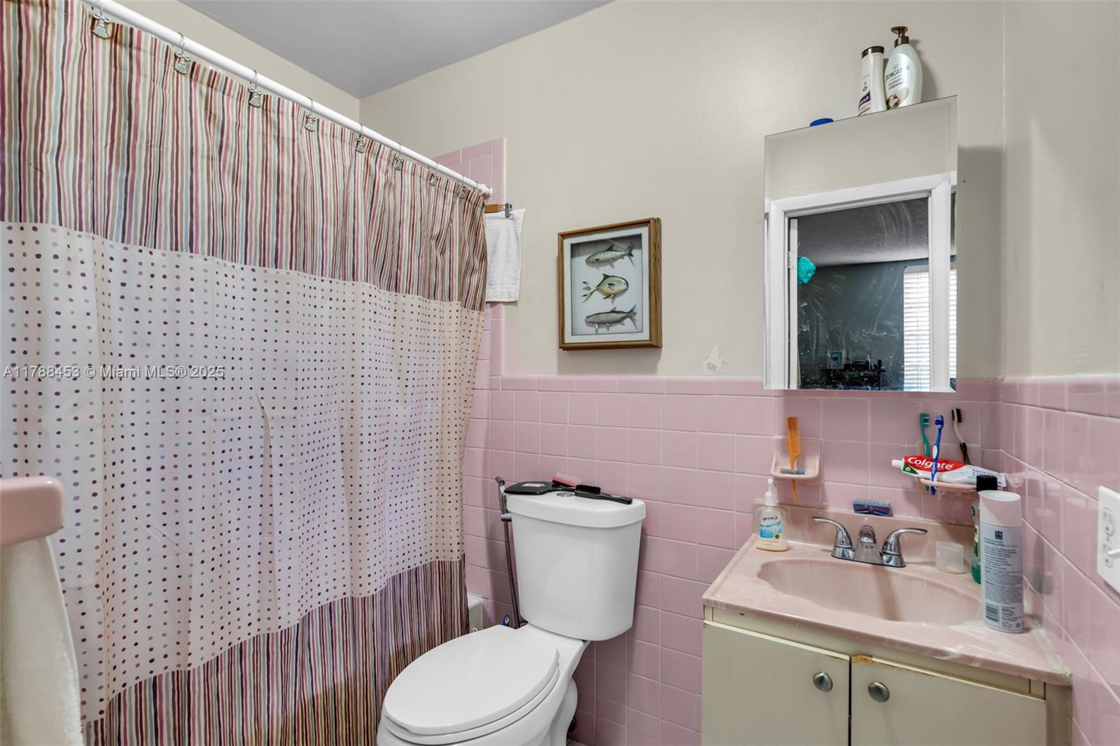 35 Southwest 60th Avenue Miami, FL 33144 - Photo 22 of 27 a bathroom with a toilet a sink and mirror