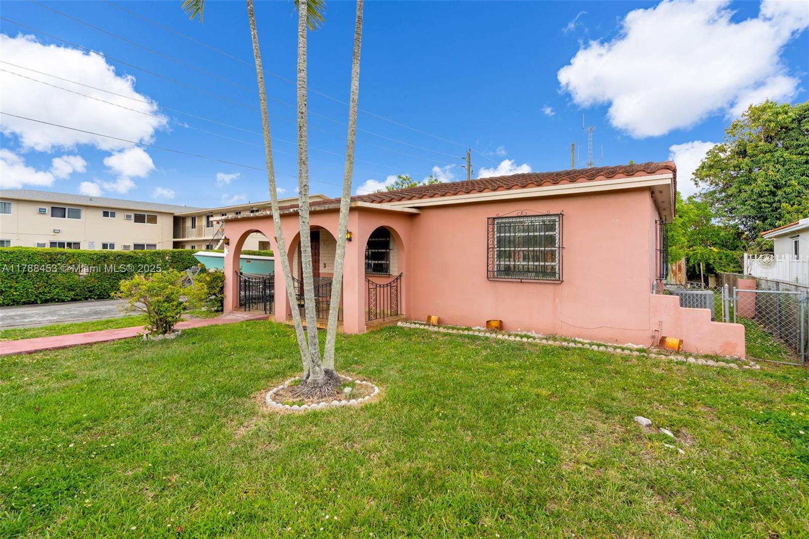 35 Southwest 60th Avenue Miami, FL 33144 - Photo 3 of 27 a backyard of a house with table and chairs