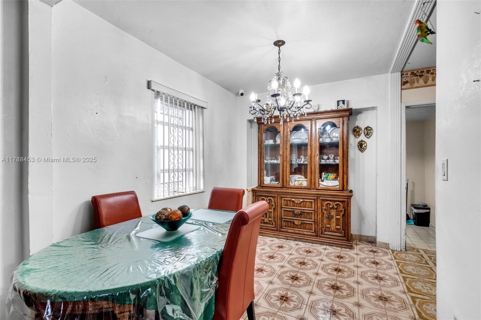 35 Southwest 60th Avenue Miami, FL 33144 - Photo 6 of 27 a dining room with furniture a rug a chandelier and wooden floor
