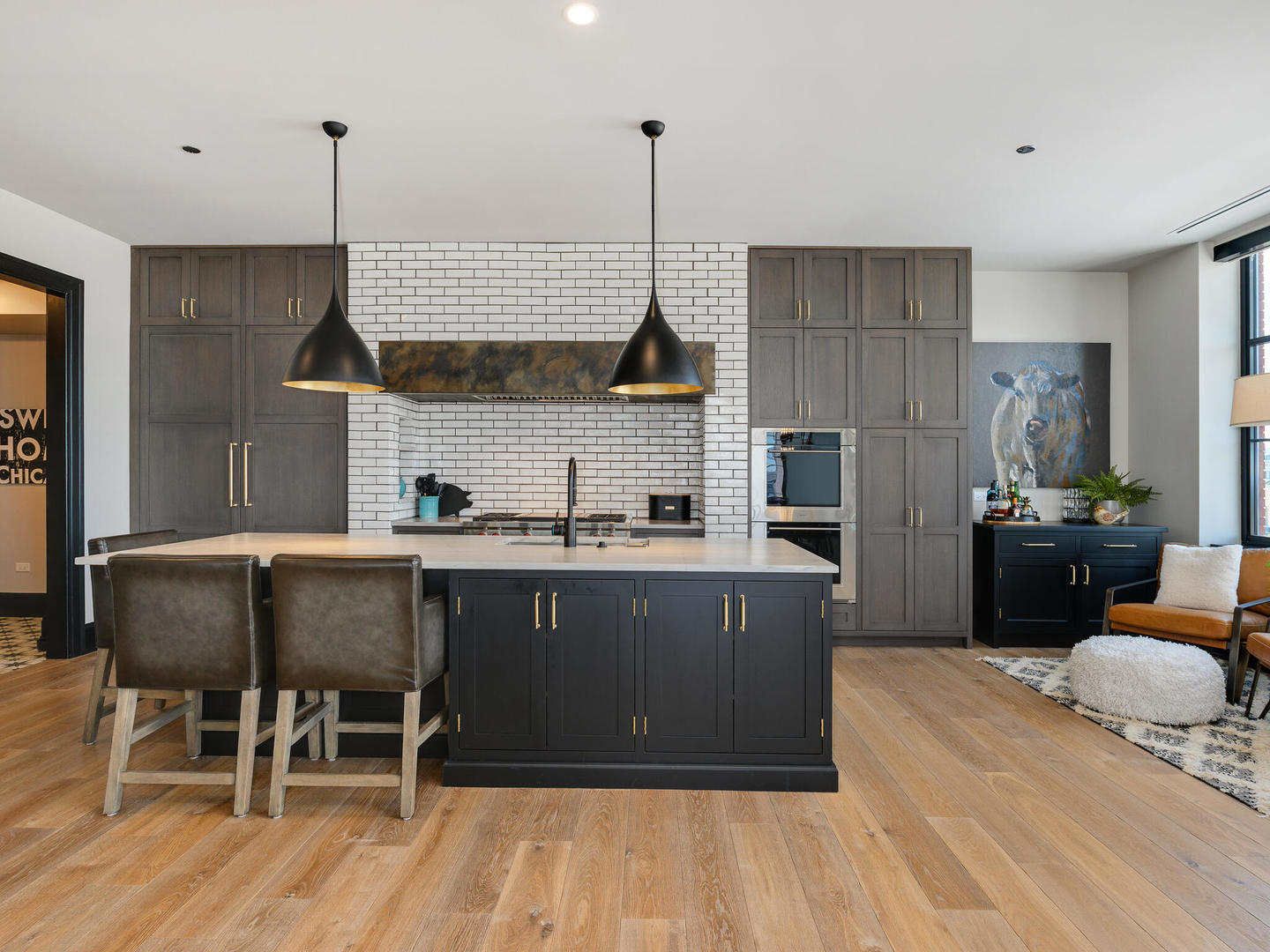 1109 West Washington Boulevard, Unit 7A Chicago, IL 60607 - Photo 18 of 41 a kitchen with kitchen island granite countertop a sink cabinets and wooden floor