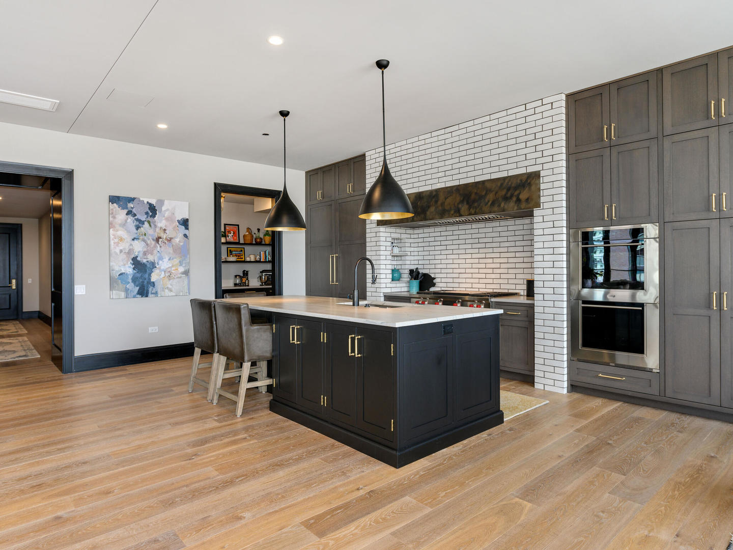 1109 West Washington Boulevard, Unit 7A Chicago, IL 60607 - Photo 19 of 41 a kitchen with stainless steel appliances kitchen island granite countertop a table chairs and a refrigerator