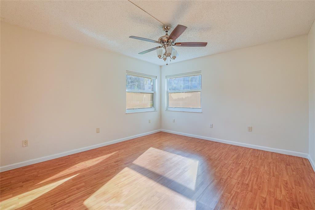 3940 Inverrary Boulevard, Unit 108A Lauderhill, FL 33319 - Photo 13 of 39 an empty room with windows and fan