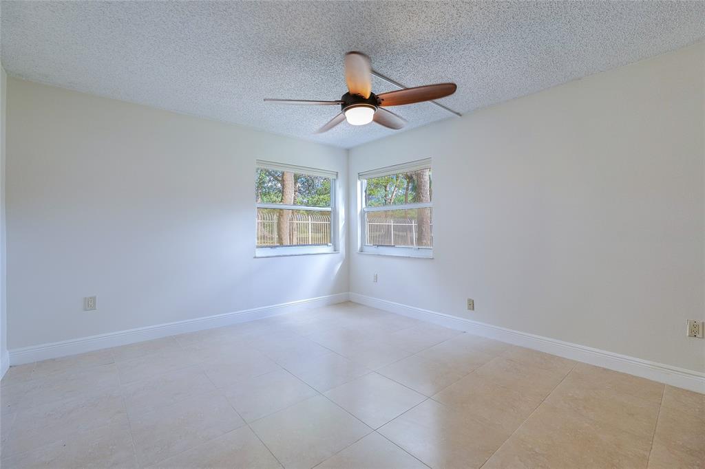 3940 Inverrary Boulevard, Unit 108A Lauderhill, FL 33319 - Photo 15 of 39 an empty room with windows and fan