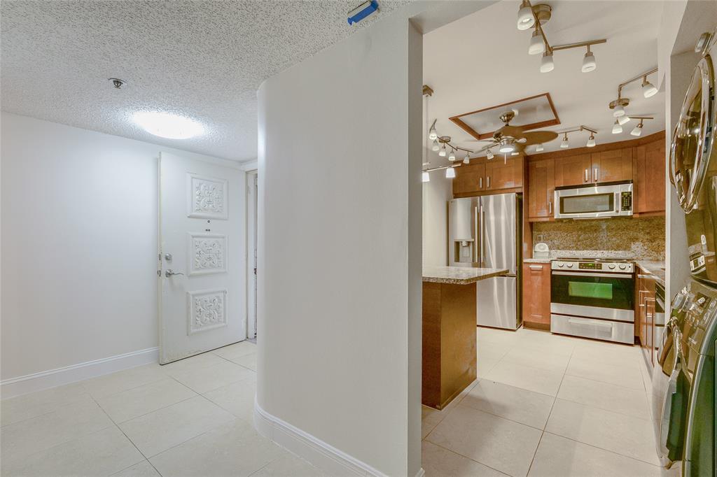 3940 Inverrary Boulevard, Unit 108A Lauderhill, FL 33319 - Photo 17 of 39 a kitchen with stainless steel appliances a refrigerator and a stove top oven