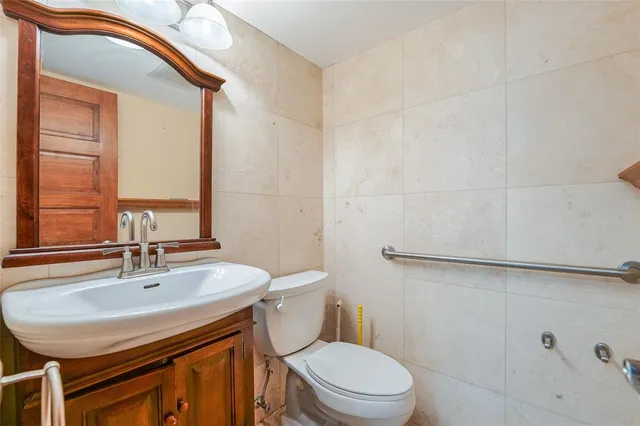 a bathroom with a sink a toilet and a mirror