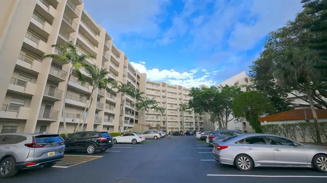 an aerial view of a house with a yard and lake view