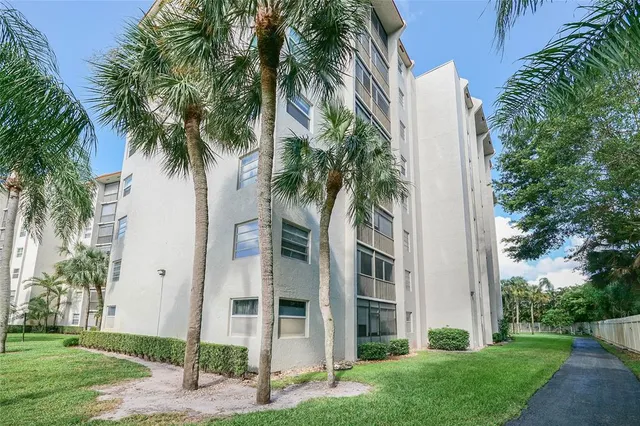 an aerial view of a house with a yard and balcony