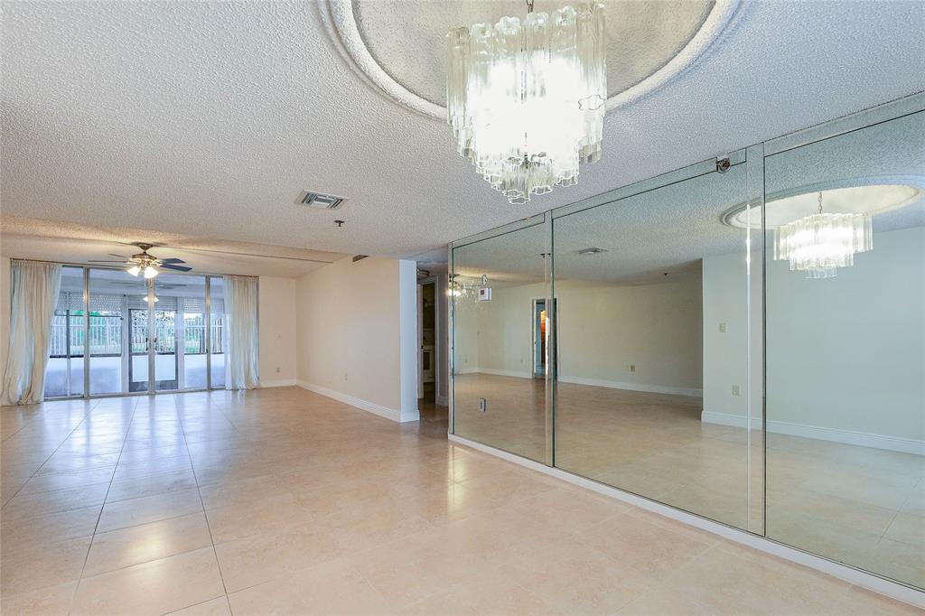 3940 Inverrary Boulevard, Unit 108A Lauderhill, FL 33319 - Photo 5 of 39 a view of an empty room with a chandelier