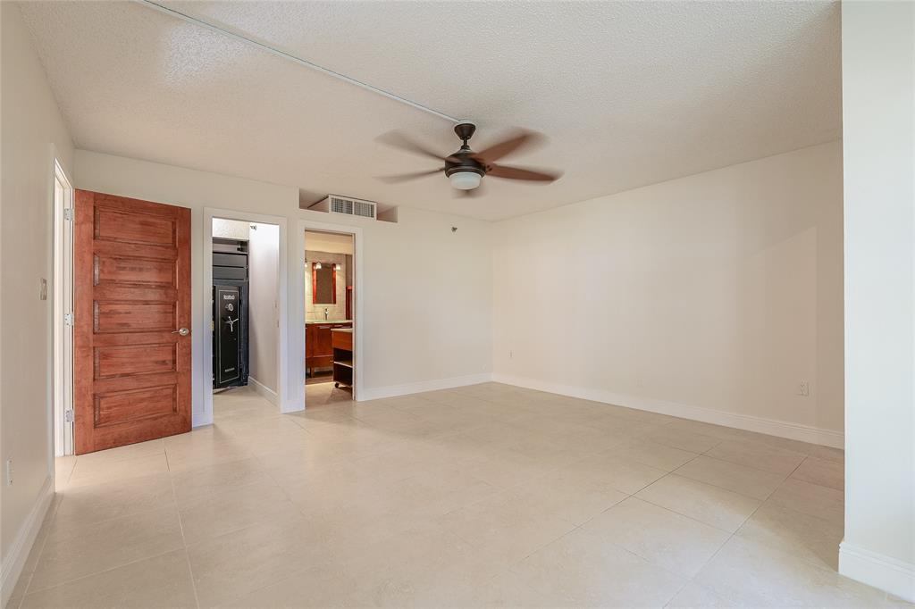3940 Inverrary Boulevard, Unit 108A Lauderhill, FL 33319 - Photo 10 of 39 an empty room with closet and a ceiling fan