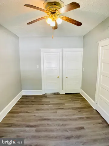 a view of room with window and wooden floor
