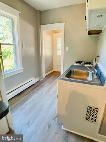 a room with a wooden floor and a window