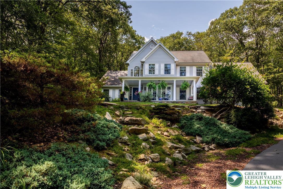 a front view of a house with a yard and potted plants