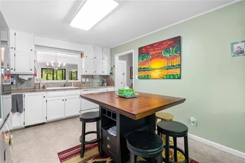 a view of a dining room with furniture wooden floor and chandelier