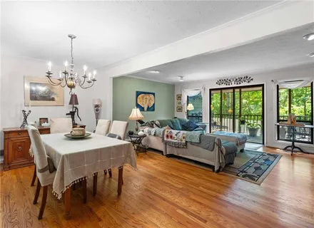 a view of a hallway with furniture and wooden floor