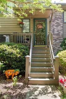 a front view of a house with a yard and outdoor seating