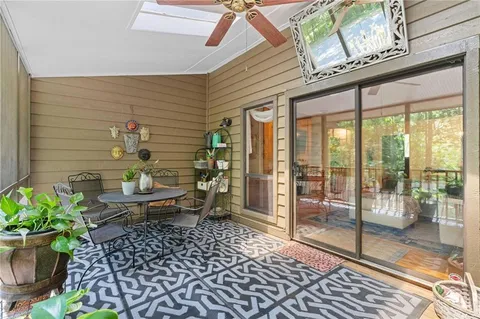 a view of a balcony with chair and wooden floor